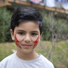 Portrait of a little boy with red lightning bolts on his cheeks in Moerwijk, The Hague