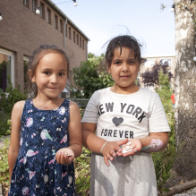 Portrait of two girls holding sea shells in Moerwijk, The Hague