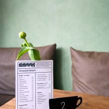 Interior photo of Smaak Haarlem displaying the menu and a flower