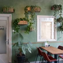 A green wall with plant pots attached to it