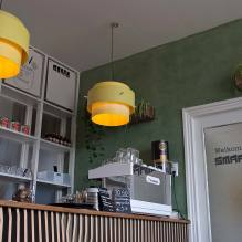 The nicely designed bar and yellow lamps at lunchroom Smaak Haarlem
