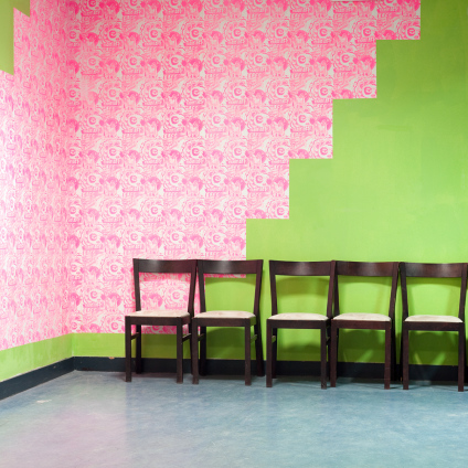 Interior photo of chairs and a funky wall