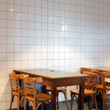 Interior photo of a tables, chairs and tiles on the wall