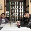 Two men sitting in restaurant Romantika in Belgrade photographed by Iris Uffen