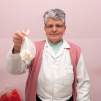 Documentary portrait of a Bosnian woman holding cheese in Sarajevo